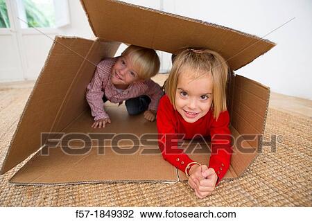 Children playing in a cardboard box View Large Photo Image Stock Image - Children playing in a cardboard box. Fotosearch