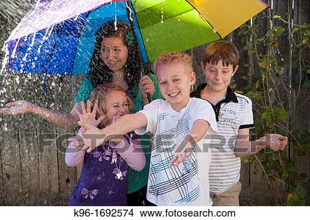 children playing in the rain View Large Photo Image Picture - children playing in the rain. Fotosearch