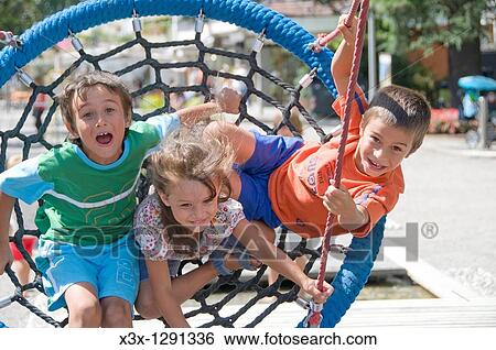 Children playing on a large net swing on playground View Large Photo Image Stock Photograph - Children playing on a large net swing on playground. Fotosearch