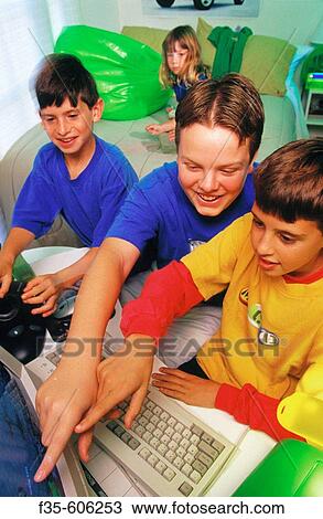 Stock Image - Children playing on computer. Fotosearch