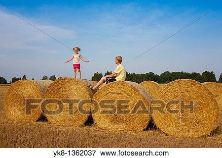 Stock Photo - Children Playing on Corn Bales, Estonia. Fotosearch