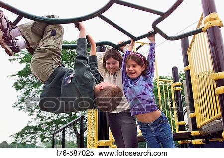 Stock Photography - Children playing on jungle gym in playground.. Fotosearch