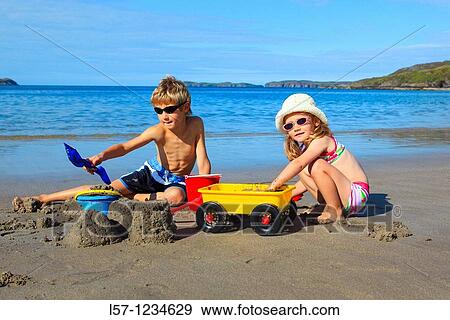 children playing on sandy beach, Sutherland, Scotland View Large Photo Image Stock Photo - children playing on sandy beach, Sutherland, Scotland. Fotosearch