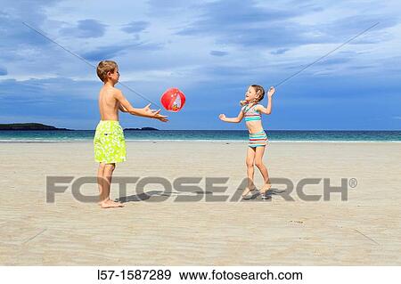 Stock Photo - children playing on sandy beach, Sutherland, Scotland. Fotosearch