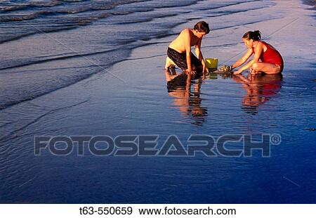 Children playing on the beach View Large Photo Image Stock Photo - Children playing on the beach. Fotosearch