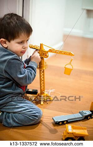 Children playing with a crane View Large Photo Image Stock Image - Children playing with a crane. Fotosearch