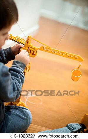 Children playing with a crane View Large Photo Image Stock Photo - Children playing with a crane. Fotosearch
