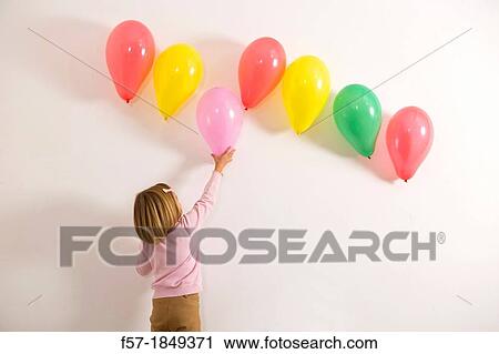 Stock Image - Children playing with balloons. Fotosearch