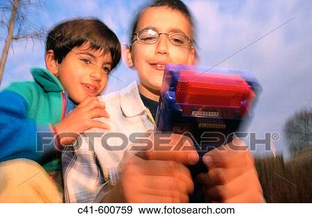 Stock Photo - Children playing with electronic games. Fotosearch