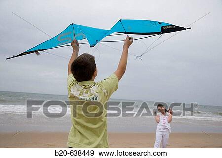 Children playing with kite on beach View Large Photo Image Stock Photo - Children playing with kite on beach. Fotosearch