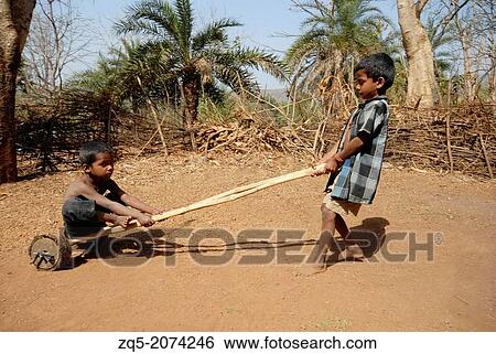 Children playing with wooden cart, Bhil Tribe, Madhya Pradesh, India. View Large Photo Image Stock Photograph - Children playing with wooden cart, Bhil Tribe, Madhya Pradesh, India.. Fotosearch