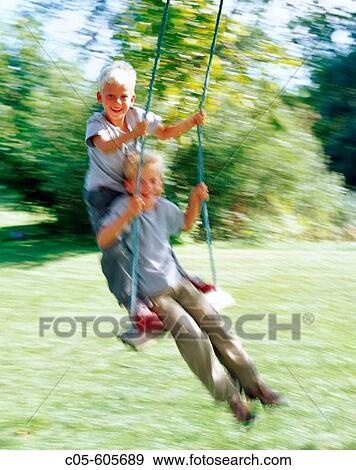 Children swinging View Large Photo Image Stock Photo - Children swinging. Fotosearch