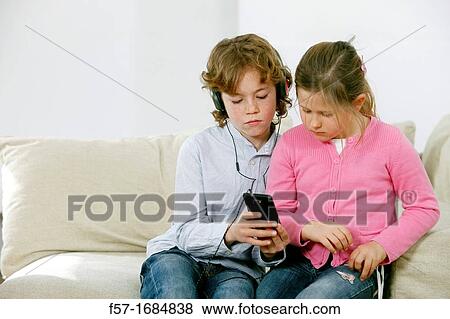 Children using smartphone View Large Photo Image Stock Photo - Children using smartphone. Fotosearch