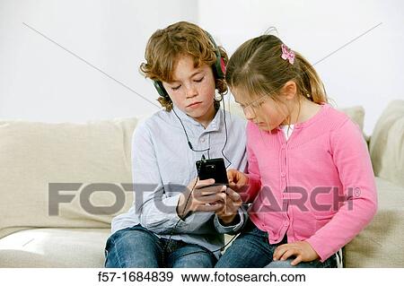 Children using smartphone View Large Photo Image Stock Photo - Children using smartphone. Fotosearch