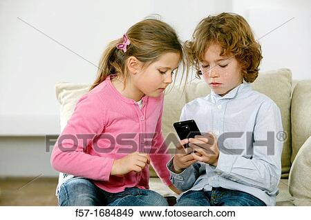 Children using smartphone View Large Photo Image Stock Photo - Children using smartphone. Fotosearch