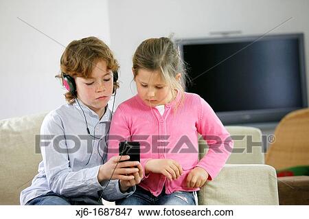 Children using smartphone View Large Photo Image Stock Photo - Children using smartphone. Fotosearch