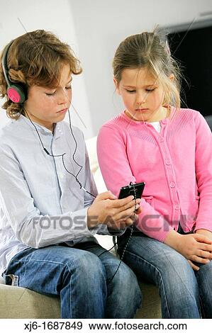 Children using smartphone View Large Photo Image Stock Photo - Children using smartphone. Fotosearch