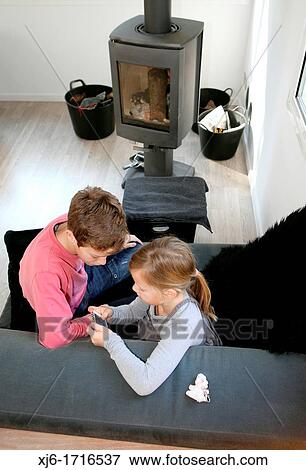 Stock Photo - Children using smartphone. Fotosearch