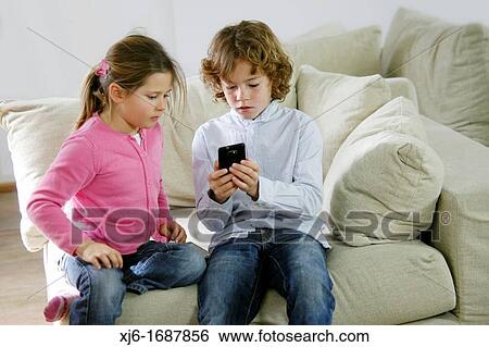 Children using smartphone View Large Photo Image Stock Photograph - Children using smartphone. Fotosearch