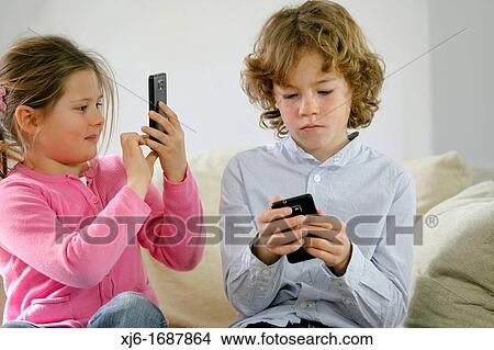 Children using smartphones View Large Photo Image Picture - Children using smartphones. Fotosearch