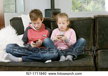 Stock Image - Children using smartphones. Fotosearch