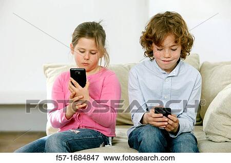 Children using smartphones View Large Photo Image Stock Photo - Children using smartphones. Fotosearch