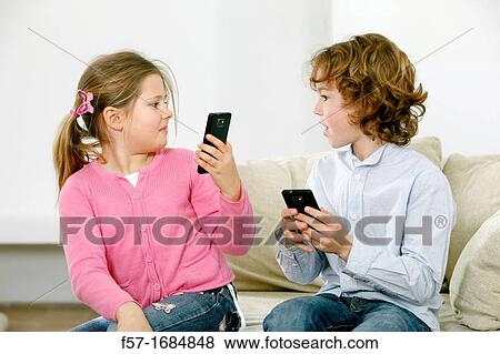 Children using smartphones View Large Photo Image Stock Photo - Children using smartphones. Fotosearch