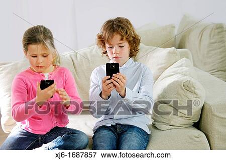 Children using smartphones View Large Photo Image Stock Photo - Children using smartphones. Fotosearch