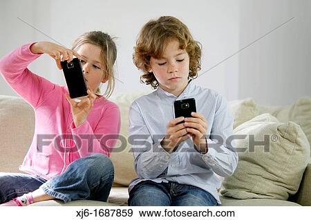 Children using smartphones View Large Photo Image Stock Photo - Children using smartphones. Fotosearch