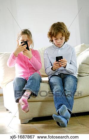 Children using smartphones View Large Photo Image Stock Photo - Children using smartphones. Fotosearch