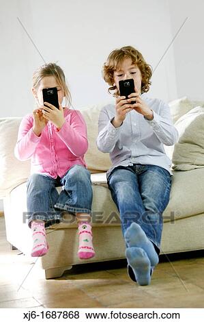 Children using smartphones View Large Photo Image Stock Photo - Children using smartphones. Fotosearch