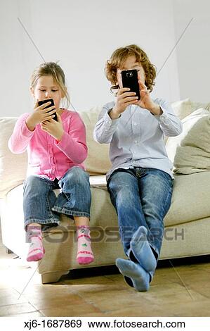 Stock Photo - Children using smartphones. Fotosearch