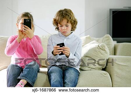 Children using smartphones View Large Photo Image Stock Photograph - Children using smartphones. Fotosearch