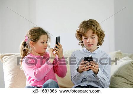 Children using smartphones View Large Photo Image Stock Photography - Children using smartphones. Fotosearch