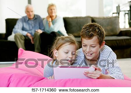 Children using tablet computer View Large Photo Image Stock Image - Children using tablet computer. Fotosearch