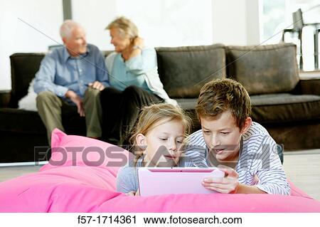 Children using tablet computer View Large Photo Image Stock Image - Children using tablet computer. Fotosearch