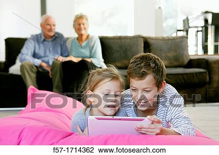 Stock Image - Children using tablet computer. Fotosearch