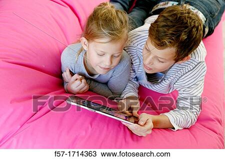 Children using tablet computer View Large Photo Image Stock Image - Children using tablet computer. Fotosearch
