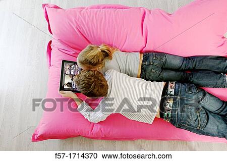 Stock Image - Children using tablet computer. Fotosearch