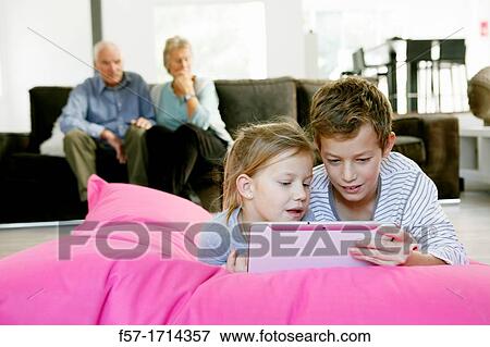 Stock Photo - Children using tablet computer. Fotosearch