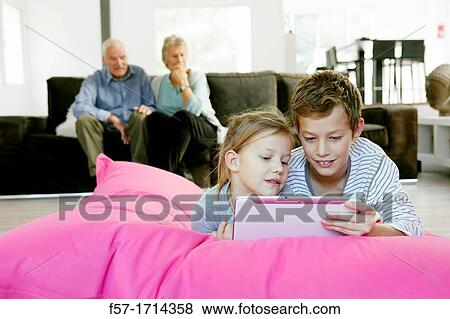 Children using tablet computer View Large Photo Image Stock Photo - Children using tablet computer. Fotosearch