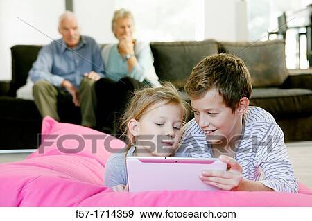 Children using tablet computer View Large Photo Image Stock Photo - Children using tablet computer. Fotosearch
