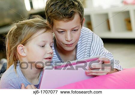 Stock Photo - Children using tablet computer. Fotosearch