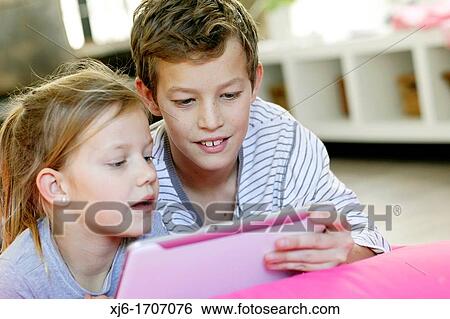Stock Photograph - Children using tablet computer. Fotosearch