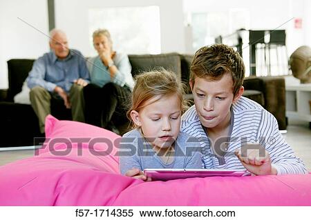Children using tablet computer View Large Photo Image Stock Photography - Children using tablet computer. Fotosearch