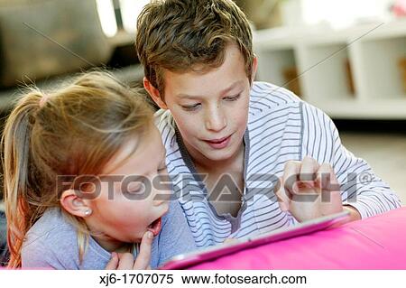 Stock Photography - Children using tablet computer. Fotosearch