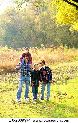Picture - Children with Parents in Beautiful Fall Color Setting.. Fotosearch