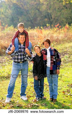 Stock Photograph - Children with Parents in Beautiful Fall Color Setting.. Fotosearch