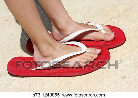 Child's feet in a big sandal View Large Photo Image Stock Photography - Child's feet in a big sandal. Fotosearch