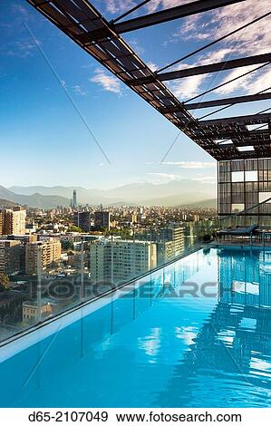 Chile, Santiago, elevated city view towards the Gran Torre Santiago tower from high rise building swimming pool, dawn. View Large Photo Image Stock Photo - Chile, Santiago, elevated city view towards the Gran Torre Santiago tower from high rise building swimming pool, dawn.. Fotosearch